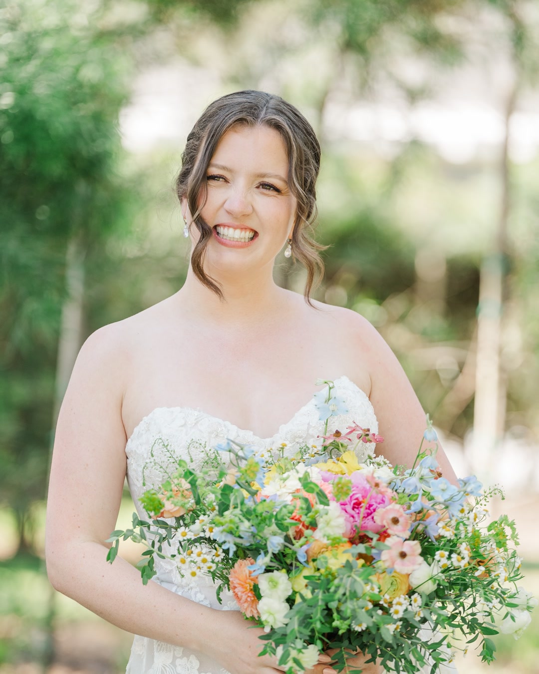 Bridal soft glam with a colorful wildflower bouquet